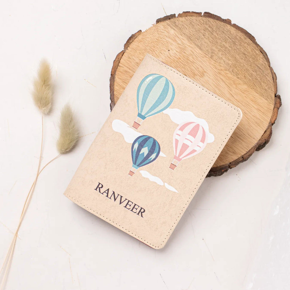 Personalised beige passport cover with balloon design with features
