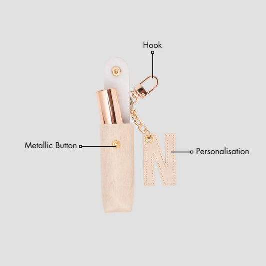 Beige keychain pouch with a lipstick inside