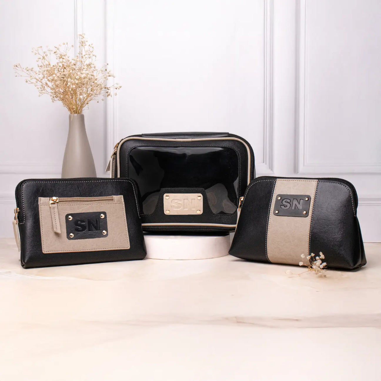 Personalised vanity kit set with black makeup pouches displayed on a tabletop