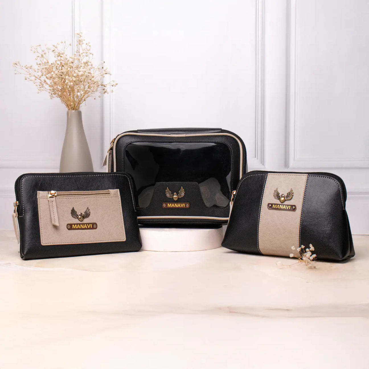 Personalised vanity kit set with black makeup pouches displayed on a tabletop