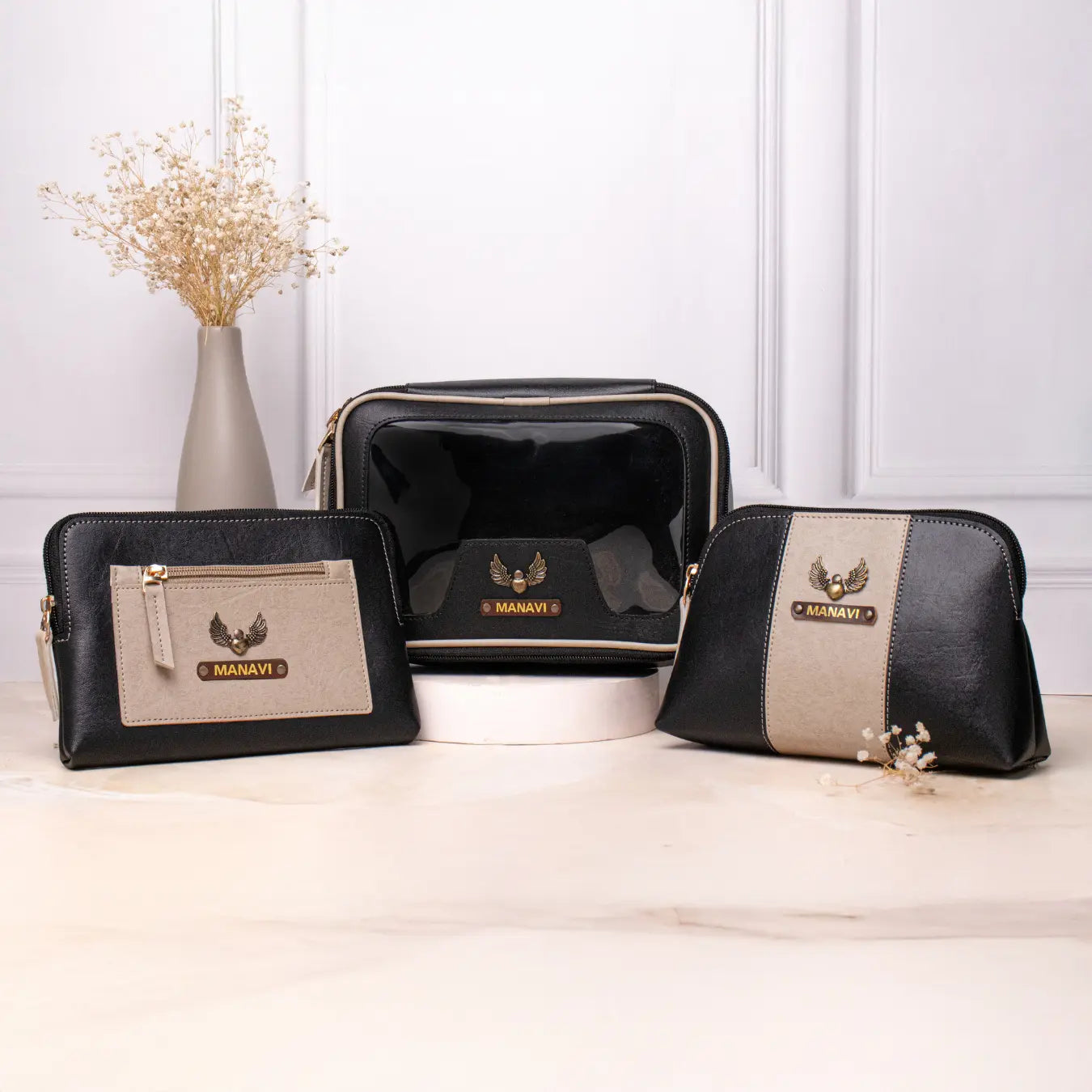 Personalised vanity kit set with black makeup pouches displayed on a tabletop