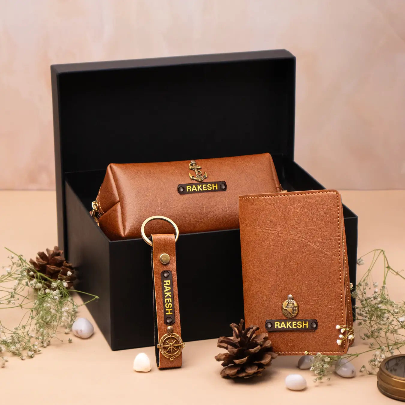 Brown leather keychain and pouch gift set arranged in a black box