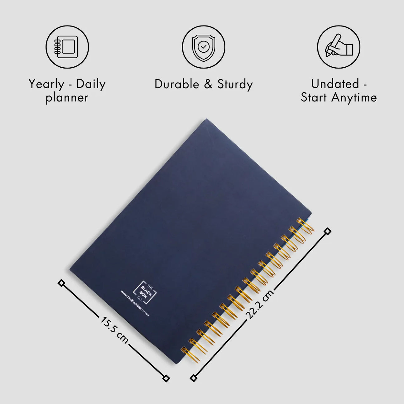 Navy blue spiral planner with gold rings.