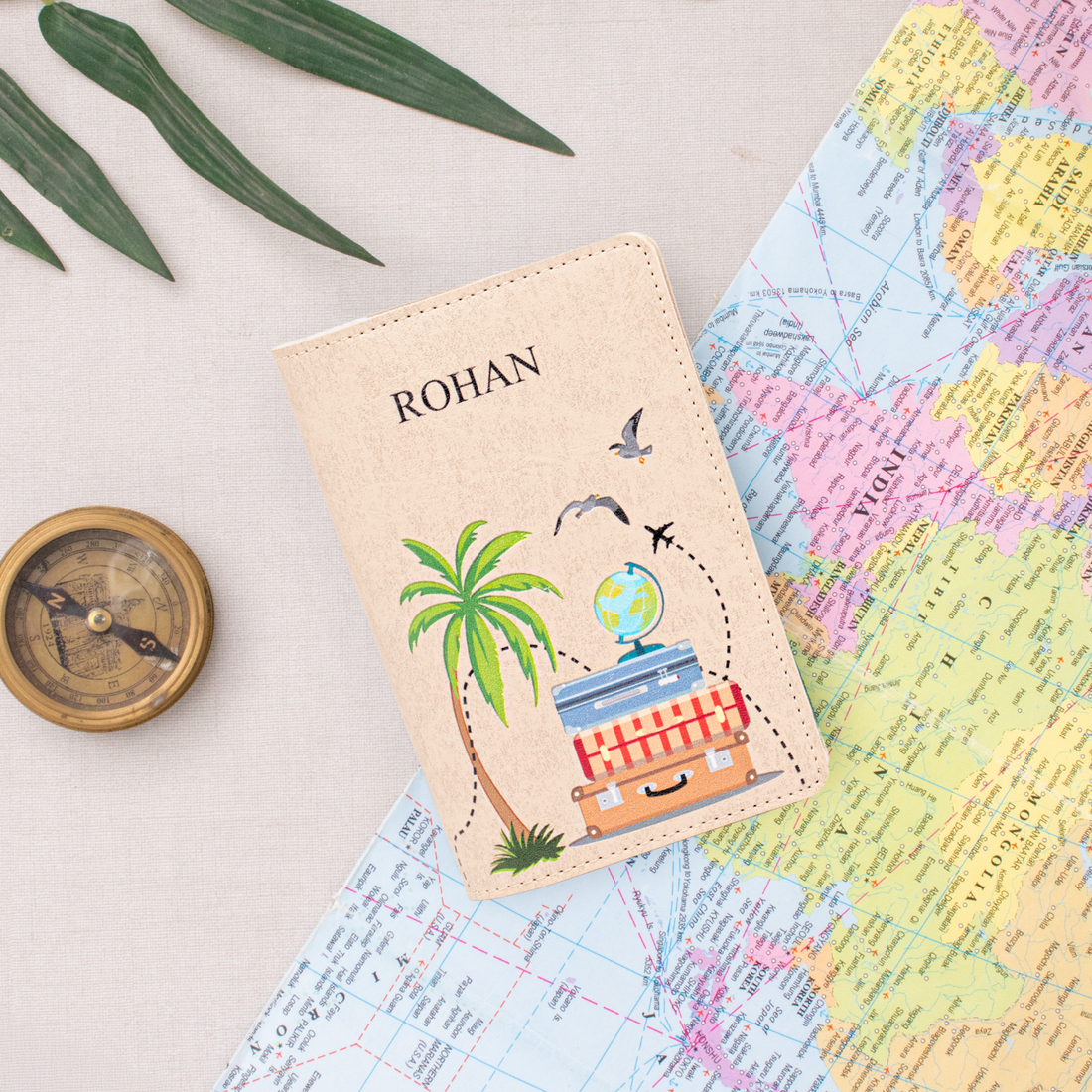 Beige personalized passport cover on a world map