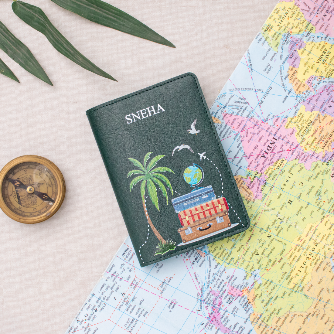 Green personalized passport cover on a world map