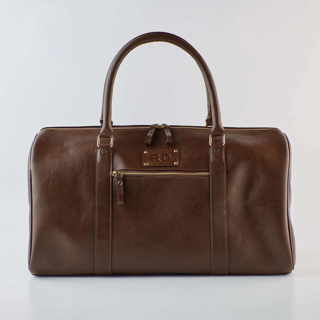 Brown duffel bag with handles and front zipper