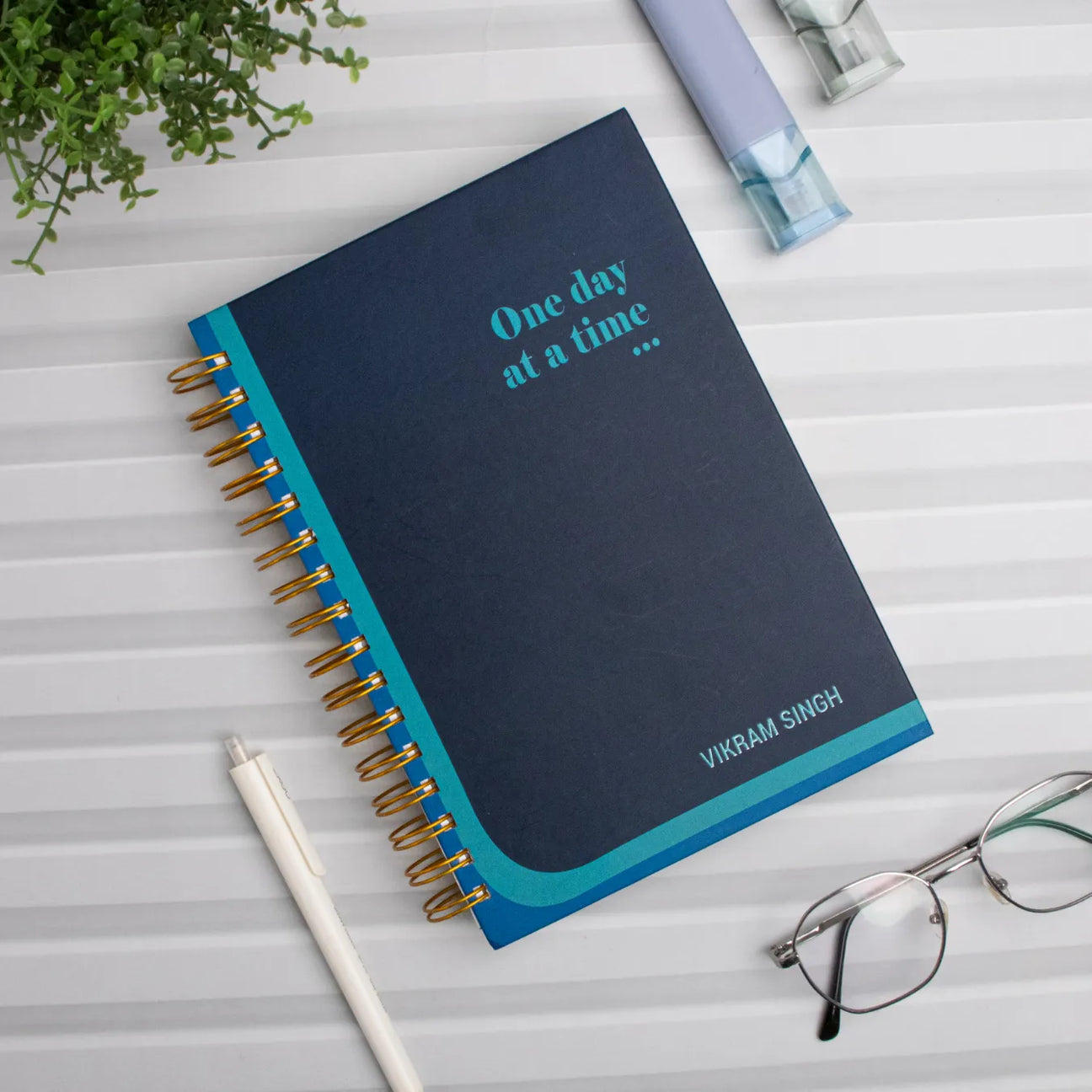 Navy spiral notebook with name 'Vikram Singh'