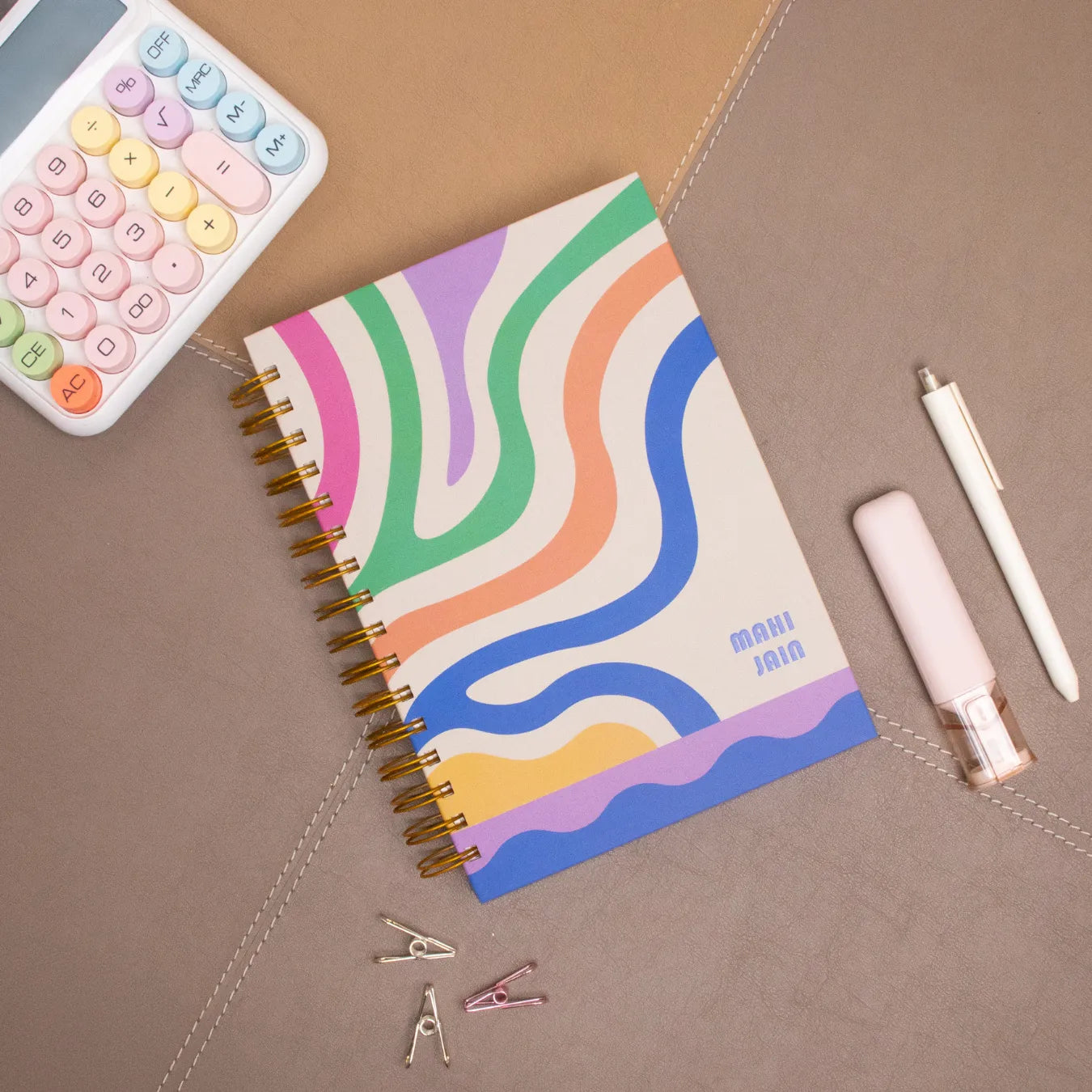 Colorful spiral notebook with name 'Mahi Jain'