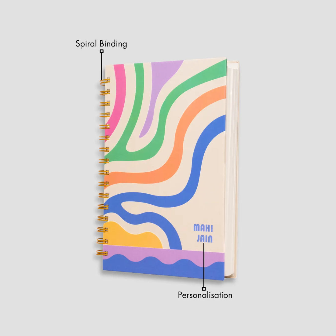 Colorful wavy notebook and coffee on a wooden table.