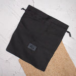 Black shoe bag  on textured background