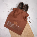 Tan drawstring shoe bag with shoes inside