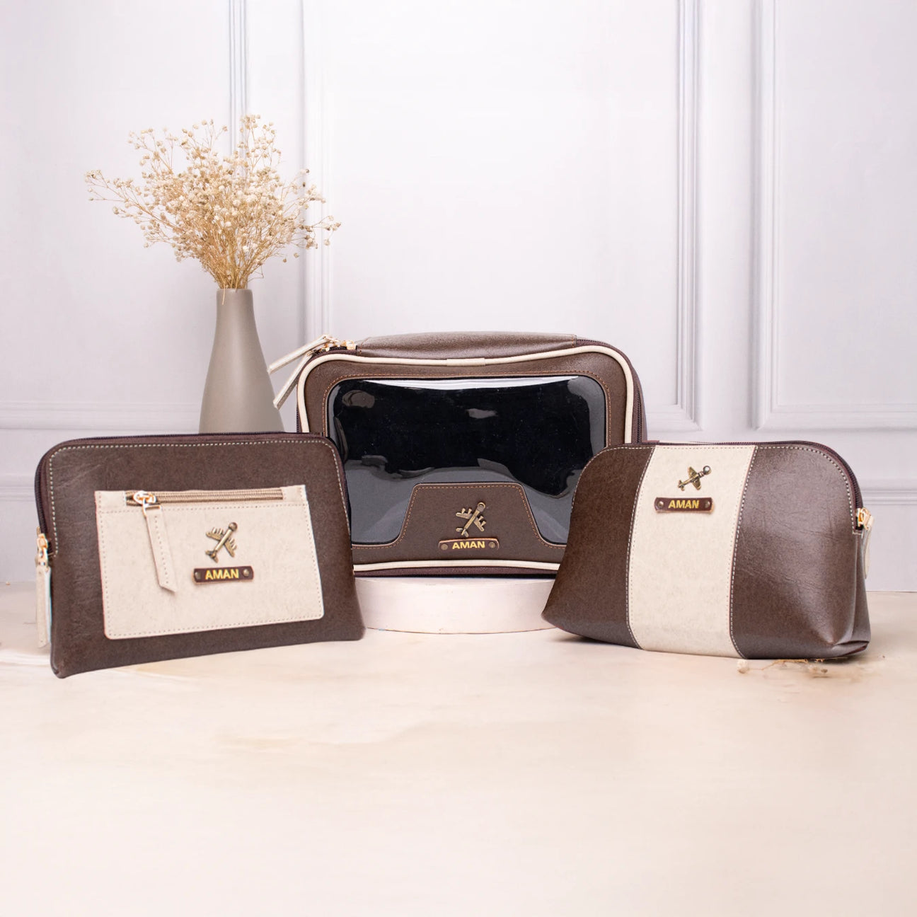 Brown and beige leather makeup pouches with zip closure and name