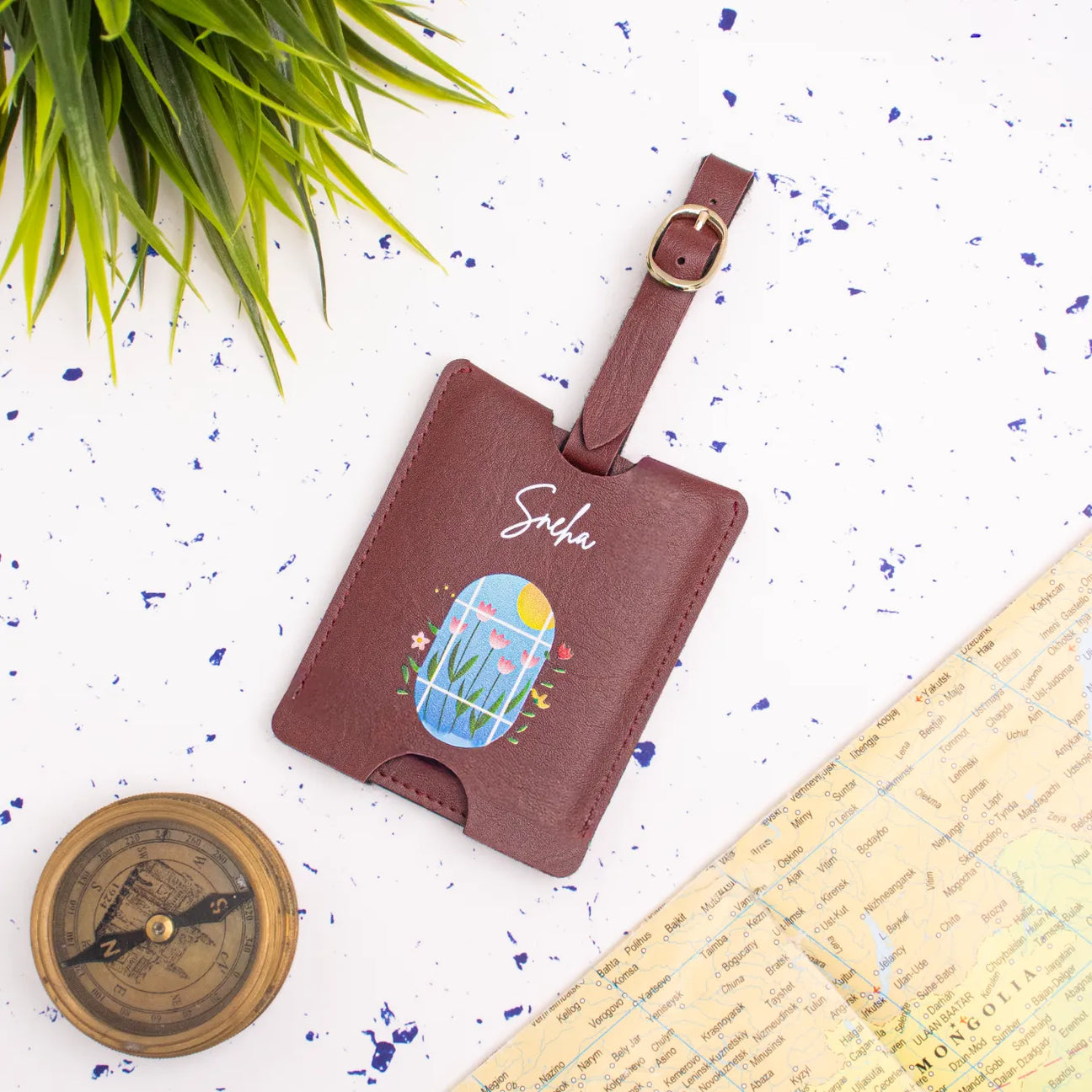 Maroon personalised travel tag on map backdrop